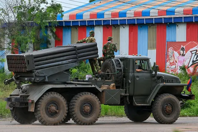 Cambodian soldiers tride a truck equipped with a Russian-made BM-21 rocket launcher in Cambodia's northern Oddar Meanchey province, which borders Thailand, on July 27, 2025. 