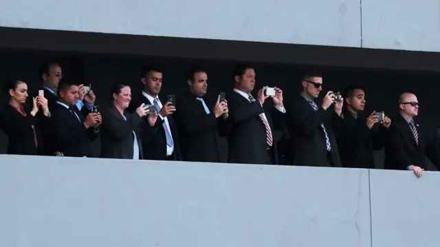 People watch as U.S. President Donald Trump boards Air Force One after his summit with North Korean leader Kim Jong Un in Singapore June 12, 2018. REUTERS/Jonathan Ernst TPX IMAGES OF THE DAY