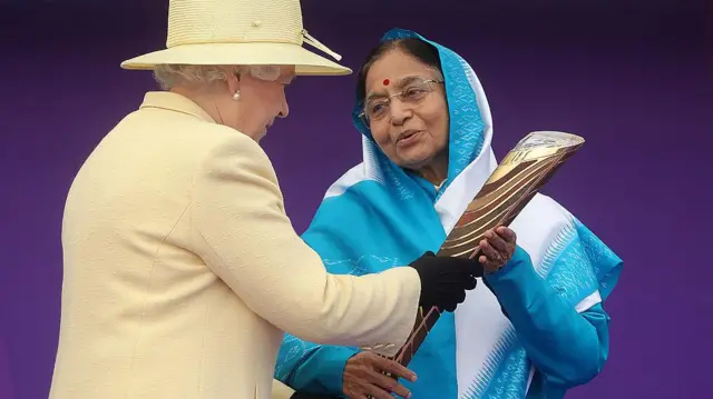 দিল্লি কমনওয়েলথ গেমসের আগে ভারতের রাষ্ট্রপতি প্রতিভা প্যাটেলের হাতে ব্যাটন তুলে দিচ্ছেন ব্রিটেনের প্রয়াত রানি এলিজাবেথ