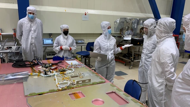 scientists working on satellite