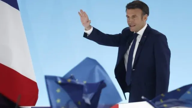 French President and candidate for re-election Emmanuel Macron react wit supporters on 10 April