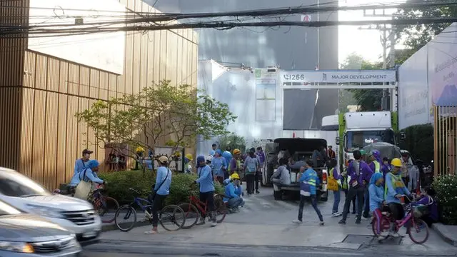 Construction workers gather in front of a construction site after tremors from a 6.1 magnitude earthquake, which hit northern Thailand, were felt, in Bangkok, Thailand, 21 November 2019