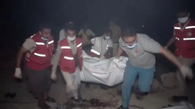  Footage from Houthi-run Al Masirah TV show as first responders dey recover some bodies near burning fuel tankers