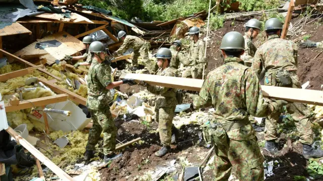 Rescue workers in the town of Atsuma