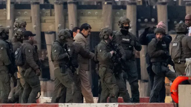 Captured Venezuelan President Nicolas Maduro is escorted, as he heads towards the Daniel Patrick Moynihan United States Courthouse in Manhattan for an initial appearance to face U.S. federal charges including narco-terrorism, conspiracy, drug trafficking, money laundering and others, at Downtown Manhattan Heliport, in New York City, U.S., January 5, 2026.