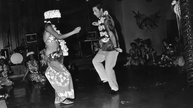 King Charles III dancing with a woman at a social function held in his honour during a Royal tour of Fiji. 