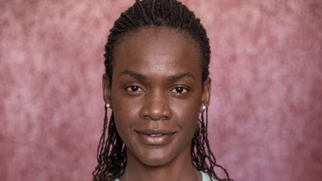 جوان شيليمو ميلي تبتسم وهي تنظر إلى الكاميرا. 