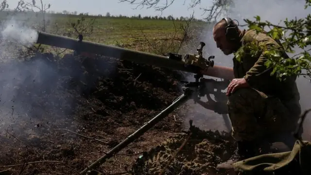 Ukrainian solider firing an anti-tank grenade launcher at a front line near Bakhmut on 3 May