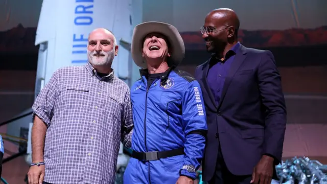 Jeff Bezos (C) stands with Chef Jose Andres (L) and Van Jones