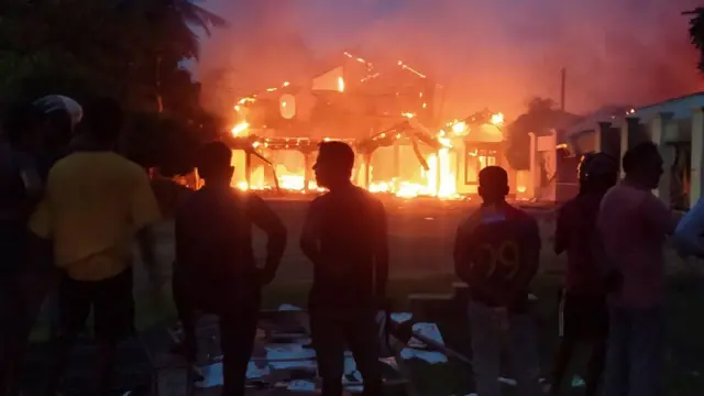 Anti-government demonstrators set fire on the house owned by minister Sanath Nishantha of resigned Prime Minister Mahinda Rajapaksa"s cabinet after ruling party supporters stormed anti-govt protest camp, amid the country"s economic crisis, in Arachchikattuwa, Sri Lanka, April 9 May 2022