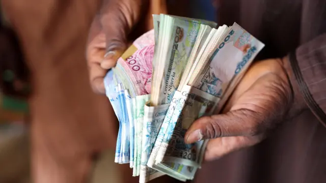 Wani mutum riƙe da takardun naira a Yola babban birnin jihar Adamawa
