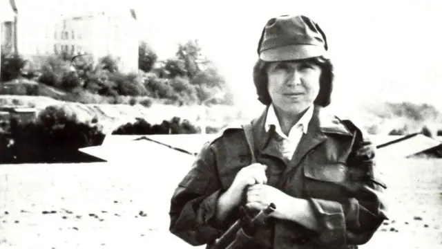 Svetlana Alexievich tại Kabul trong trang phục quân sự, khoác súng máy trên vai