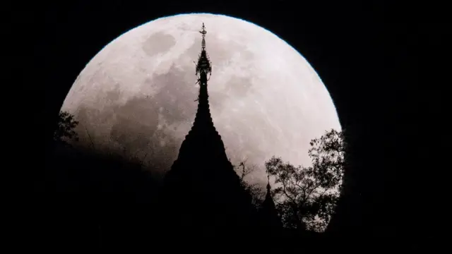 The moon rises over a pagoda in Kumal, some 105 kms away from Mandalay City on January 31, 2018.