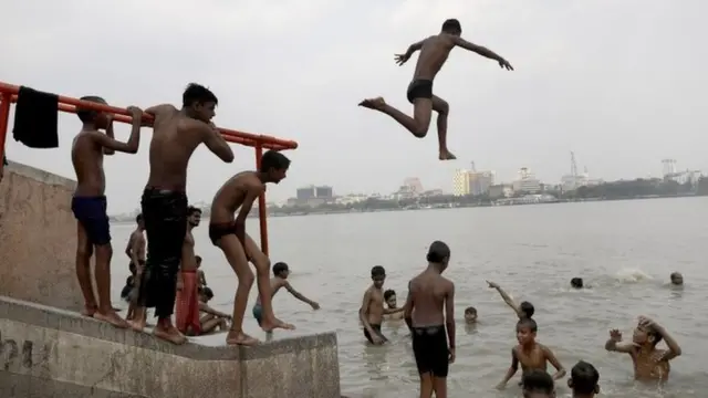 A boy dives into the Ganges River during a hot day in Kolkata, India, 20 April 2022. The summer, or pre-monsoon season, occurs from March to July in eastern India, with the highest daytime temperatures ranging from 35 to 45 degrees Celsius.
