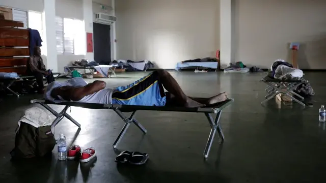 People who were evacuated from their homes are seen in a room at a soccer stadium being used as a shelter while Hurricane Matthew approaches Kingston, Jamaica October 3, 2016.