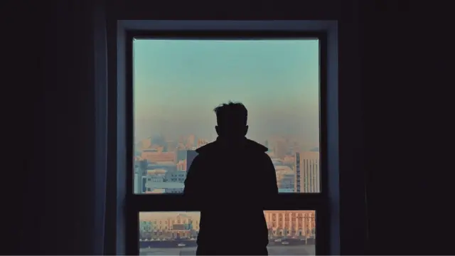 Man standing at a window