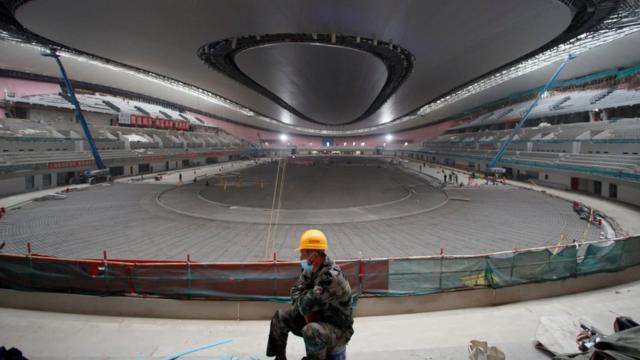 A construction worker sits in the National Speed Skating Oval, known colloquially as the "Ice Ribbon", which will host the 2021 World Speed Skating Championships and the speed skating competitions at the 2022 Winter Olympics in Beijing, China, September 23, 2020.