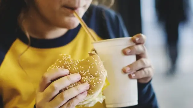 teenage girl eating fast food