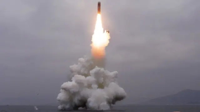 What appears to be a submarine-launched ballistic missile (SLBM) flies in an undisclosed location in this undated picture released by North Korea's official news agency
