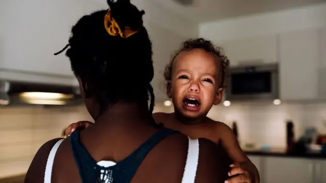 ልጅ ያቀፈች ሴት