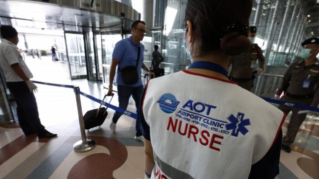 Thai officials monitor arrivals at Suvarnabhumi International Airport in Bangkok