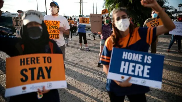 People hold signs during a rally in support of the Supreme Court&#x27;s ruling in favor of the Deferred Action for Childhood Arrivals programme in San Diego, California