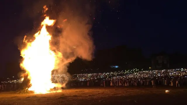 People watch the bonfire in Addis Ababa