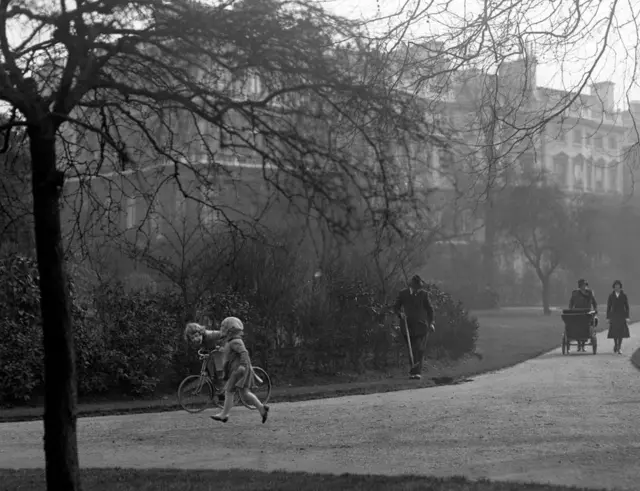 Princess Elizabeth on a tricycle in the park