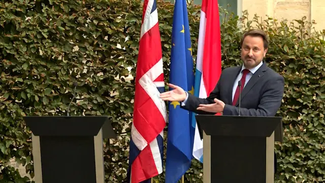 Luxembourg's Prime Minister Xavier Bettel gestures to an empty podium as he speaks to the press after meeting the UK Prime Minister in Luxembourg. 16 September 2019