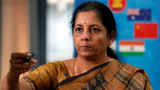India"s Commerce and Industry Minister Nirmala Sitharaman returns a microphone after speaking with media at the 3rd Intersessional Regional Comprehensive Economic Partnership (RCEP) Ministerial Meeting in Hanoi, Vietnam May 22, 2017