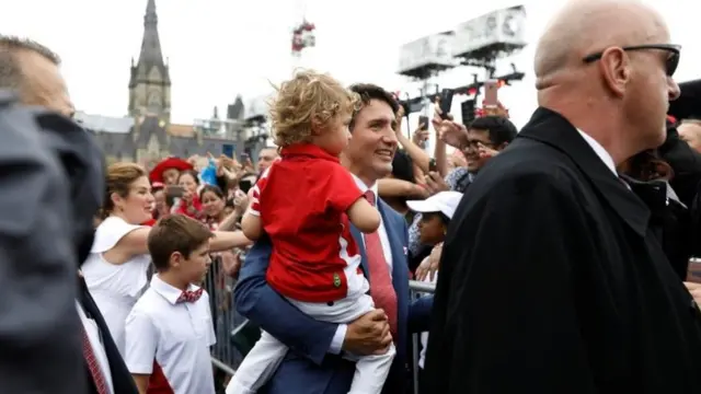 Canada's Prime Minister Justin Trudeau, holding his son Hadrien, arrives with his family on Parliament Hill during Canada Day celebrations as the country marks its 150th anniversary since confederation, in Ottawa, Canada 1 July 2017.