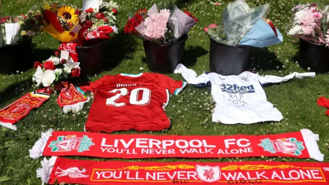 Torcedores do Liverpool deixam objetos e flores em homenagem a Diogo Jota na frente do estádio Anfield