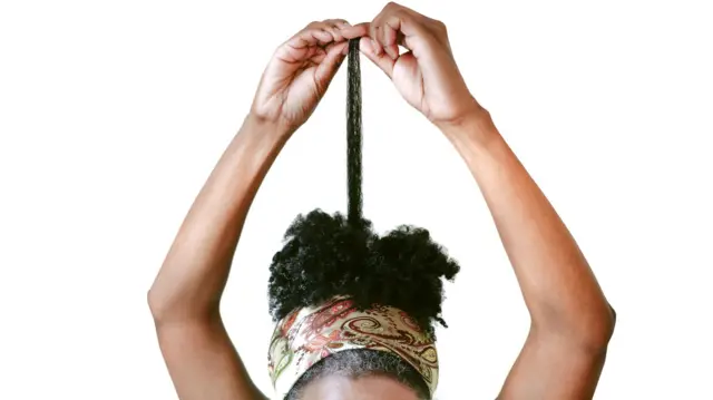 Woman wey dey observe her long gray hair
