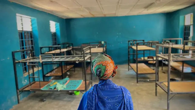 One woman stand inside one empty boarding hostel