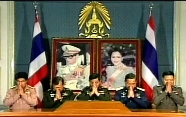 V grab from Chanel 5 shows Thailand's coup leader, General Sonthi Boonyaratglin (C) greeting during the annoucement of military coup at the army headquarters in Bangkok, 20 September 2006.