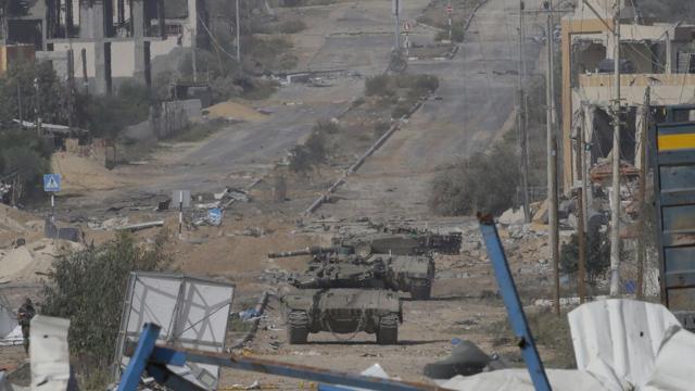 Israeli tanks move along Salah al-Din Road in the central Gaza Strip