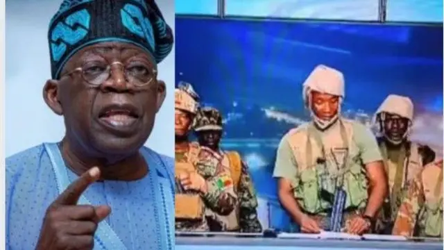 Aarẹ Bola Tinubu wọ asọ ati fila olomi buluu, o na ika si ọọkan pẹlu aworan awọn ologun nilẹ Benin