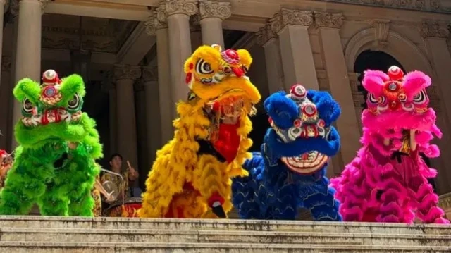 Четыре традиционных китайских фигуры льва: одна зеленая, одна желтая, одна синяя и одна розовая.