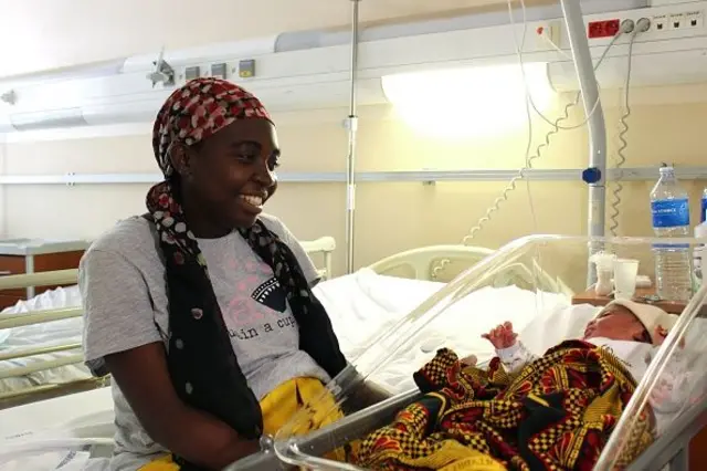 Mariama, a Mahorais woman from Mayotte, smiles by her newborn baby in maternity ward of the Mayotte Maternity Hospital in Mamoudzou on March 14, 2018. - Pregnant women arrive in Mayotte by boat from nearby islands to give birth on French soil, as a way of obtaining French and EU citizenship for their child. Around 70 percent of the 10,000 babies born every year in the maternity hospital in Mamoudzou are born to illegal migrants, mainly from the nearby Comoran islands of Anjouan, Moheli and Grande Comore, according to official statistics.