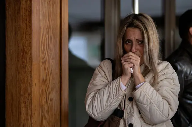 Жінка молиться біля входу в лікарню Сант-Каміль в Сант-Пере-де-Рібес у Барселоні 