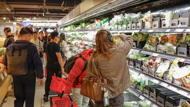 Shoppers seen browsing at a supermarket.