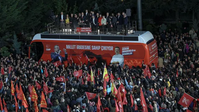 Özgür Özel 21 Mayıs 2026'da Ankara'daki CHP genel merkezi önünde toplanan kalabalığa, parti otobüsü üzerinden sesleniyor. 