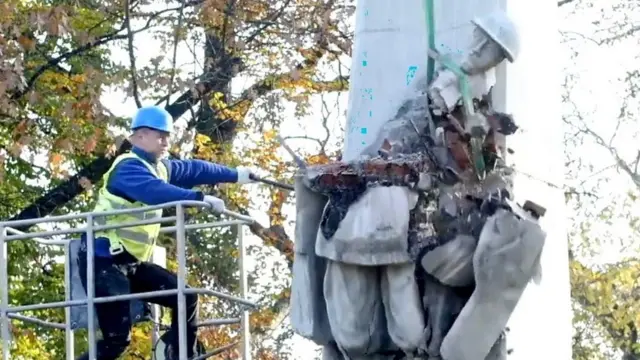 Man destroying monument in Poland