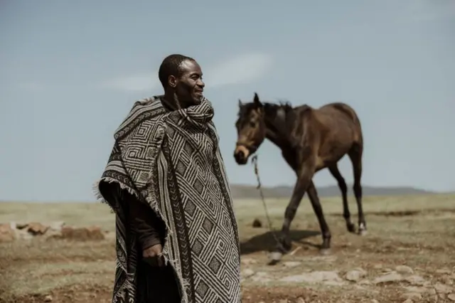 Breeder Moeketsi Maieane and his two-year-old Basotho pony, Morumua Hana Lonya, pose outside his house in Lesotho...