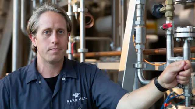 US distiller Ryan Christiansen looks at the camera