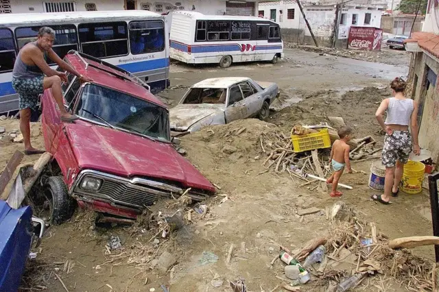 Un hombre observa los daños en una calle cubierta de barro tras las fuertes lluvias que provocaron deslizamientos de tierra e inundaciones en La Guaira, en 1999. 