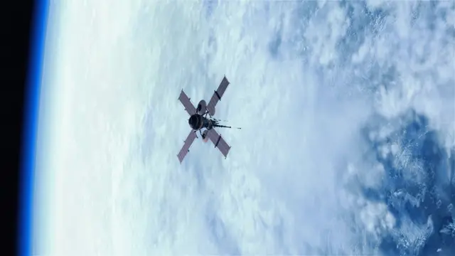 Ilustrasi sebuah satelit sedang mengorbit di atas bumi.