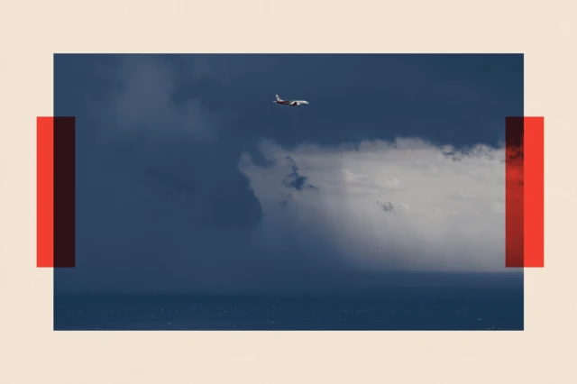 A plane flies over the Port of Barcelona