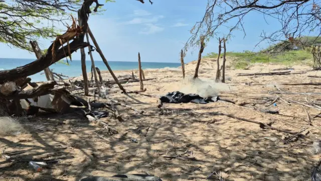 view of the sea and metal remains in the town of Poolosü in the Venezuelan Alta Guajira