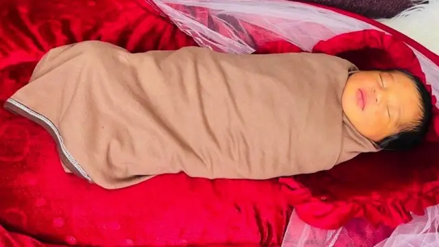 Omayma, wrapped in a blanket